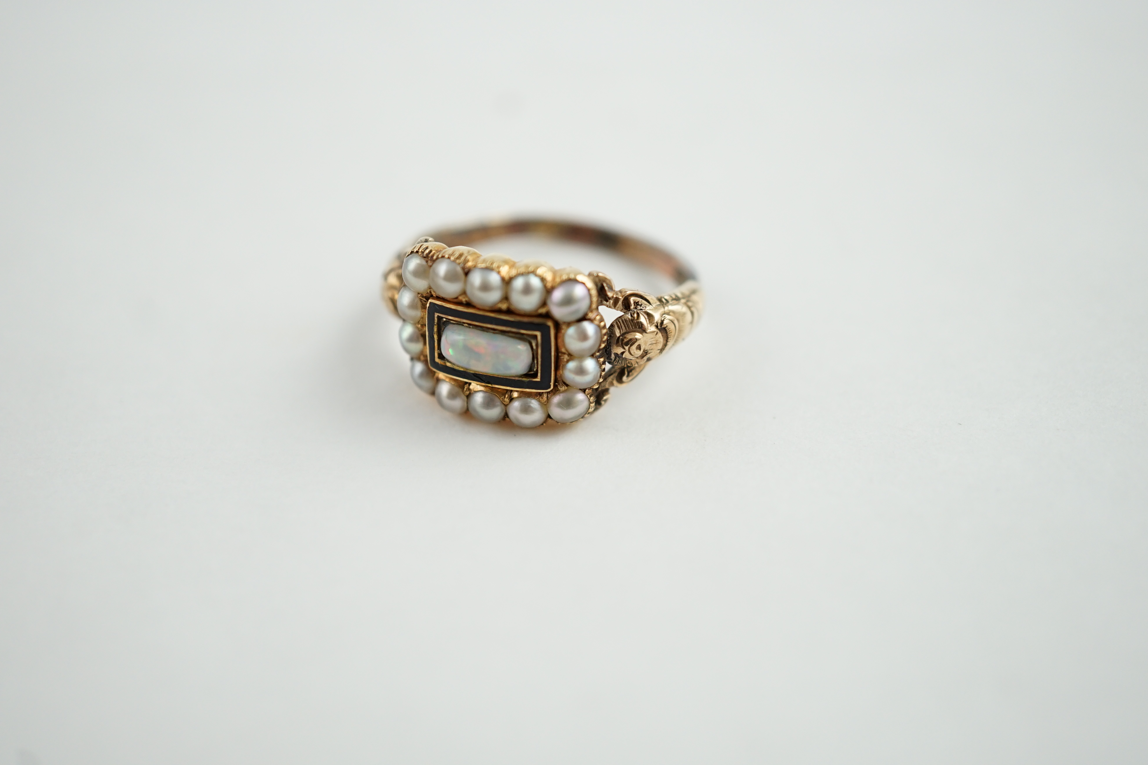 An early Victorian gold, enamel and split pearl mourning ring